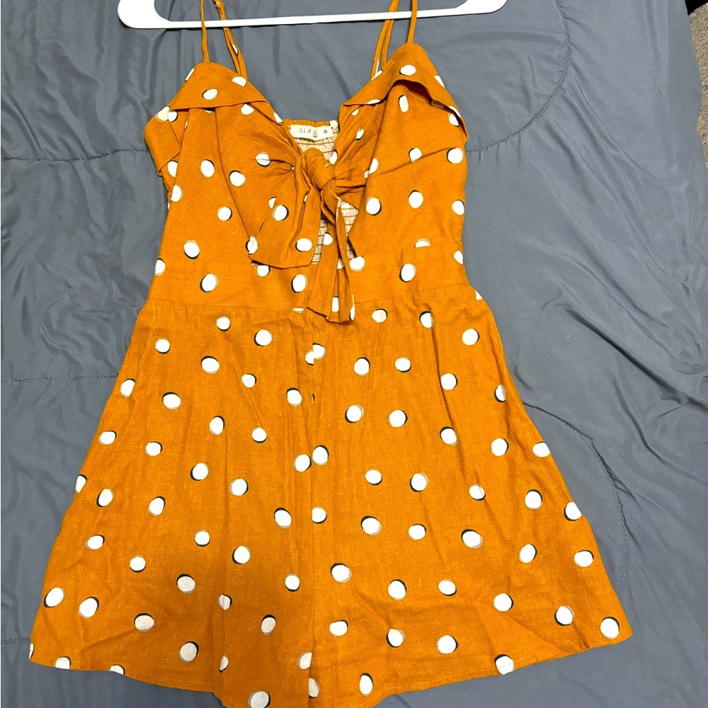 Women’s brown with white polka dot romper.